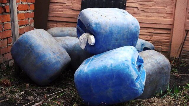 bunch of blue cans lying around in chaotic pores