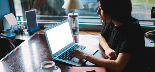 Focused woman typing on laptop during work