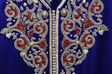 Details of a blue Moroccan caftan for women,  and golden lace