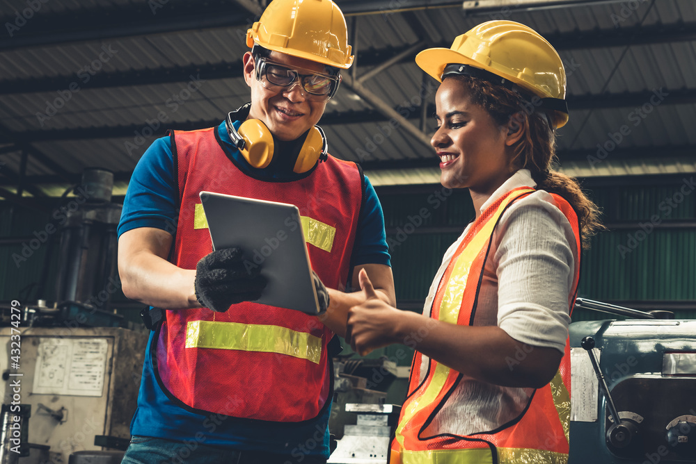 Poster two skillful factory engineer or worker discussing project on tablet computer . industrial people an