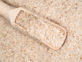 top view of wooden scoop in Psyllium husk
