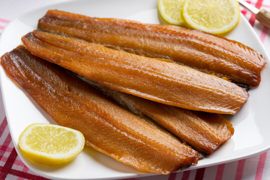 Plate with a pair of kippers, fillet smoked herring,  for breakfast or lunch 