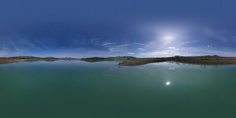 360 degree aerial photo of Ogliastro lake in the heart of Sicily with Etna view. Place of great naturalistic value surrounded by hills planted with cereals. A destination for migratory bird species.