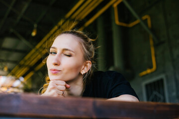 A young woman lies on a table and looks at the camera with a wink. Positive attitude.