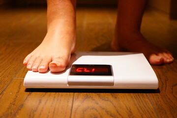 Man measuring his weight using Scales on Floor - 体重を量る男性