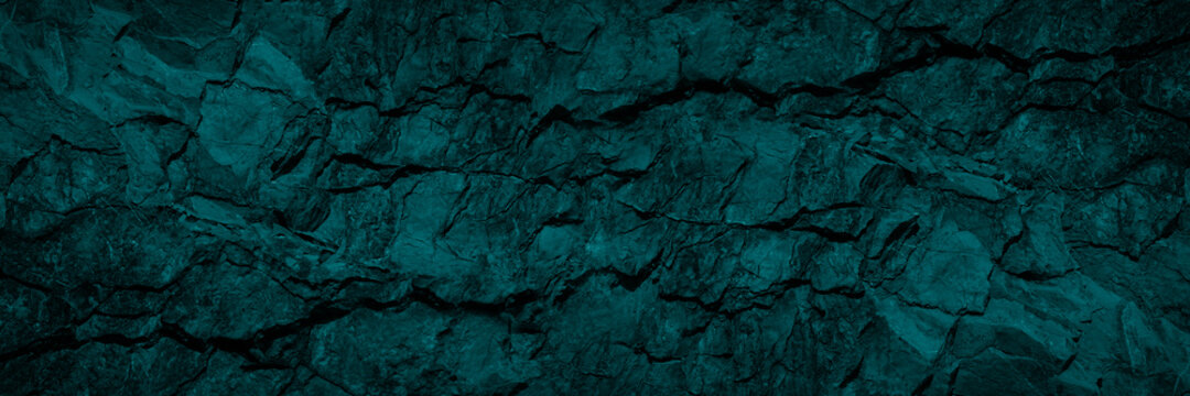 Green blue stone background. Cracked granite surface. Beautiful toned rock texture. Dark teal background with copy space for design. Wide banner.
