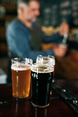 close up of glasses of beer on bar counter