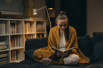 woman reading book at home