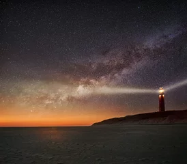 Foto op Canvas Night image of the Texel lighthouse serving as a navigation beacon for ships with starry nightsky with Milky way galactic core © Donald
