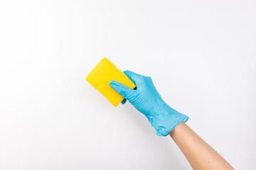 Sponge for washing dishes in female hand. Hand in a latex glove. Woman's hand gesture or sign isolated on white. A hand in a glove holds a sponge for washing and cleaning dishes