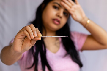 analog thermometer and an woman
