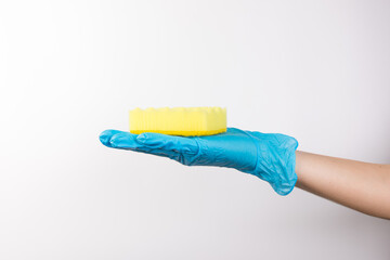 Sponge for washing dishes in female hand. Hand in a latex glove. Woman's hand gesture or sign isolated on white. A hand in a glove holds a sponge for washing and cleaning dishes