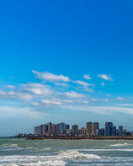 Fototapeta premium Plain coastline with high buildings and blue sky