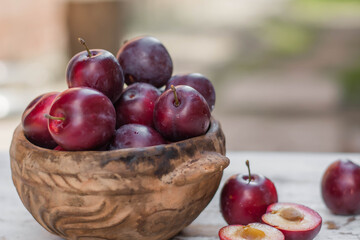 Naklejka na ściany i meble ripe plums on the table