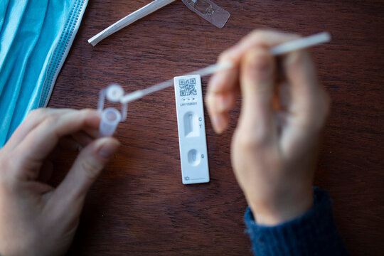 Close up of a person using coronavirus covid-19 rapid antigen home testing kit