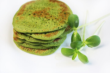Green pancakes from herbs. Healthy vegetarian breakfast. Gluten free food. For background, menu, design. 