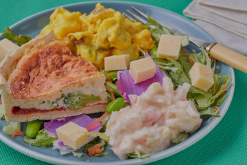 Quiche with mixed salad and coleslaw.