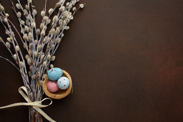 Easter greeting card with chocolate eggs and colorful candies. Top view on stone table with space for your greetings