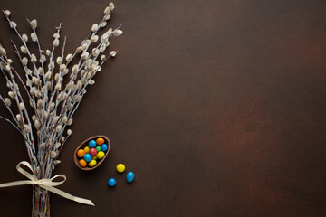 Easter greeting card with chocolate eggs and colorful candies. Top view on stone table with space for your greetings