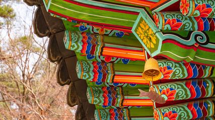 Korean traditional colorful eaves with golden fish shape bell