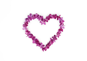 Heart made of lilac flowers isolated on a white background. Top view, copy space.
