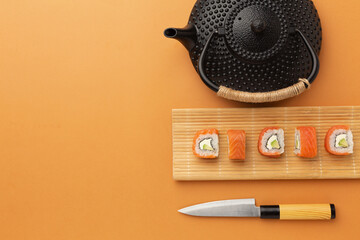 Sushi set sashimi and sushi rolls served on stone slate