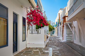 Beautiful traditional narrow streets of Greek island towns. Whitewashed houses, bougainvillea, balconies, stairs, shops, cafes. Mykonos, Greece