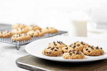 Delicious Whole Wheat Chocolate Chip Cookies set on white cafe table.