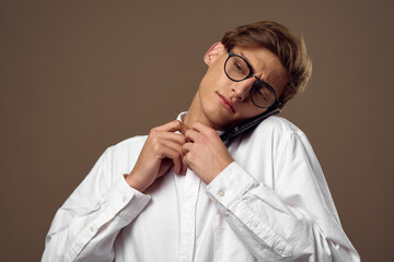 business man in shirt wearing glasses talking on the phone manager office