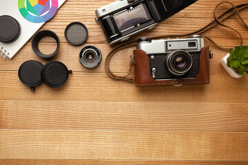 Photographer's desk made of wood with a camera and palettes.
