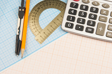 Mathematical instruments over the corner of a math graph paper with copy space for text. Math...