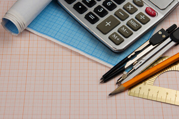 Mathematical instruments over the corner of a math graph paper with copy space for text. Math...