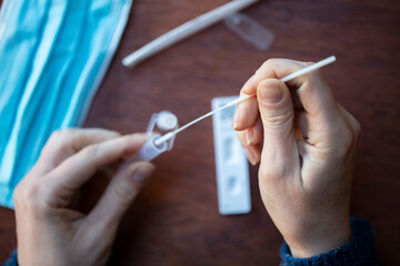 Close up of a person using coronavirus covid-19 rapid antigen home testing kit