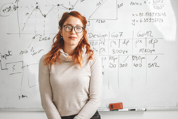 Portrait of red hair female professor. She lecture about new technologies and software...