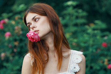 Woman in white dress outdoors flowers bush luxury