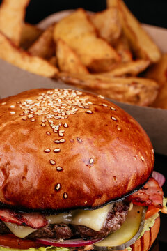 Juicy and sliced ​​burger with meat cutlet close up. on a black background.