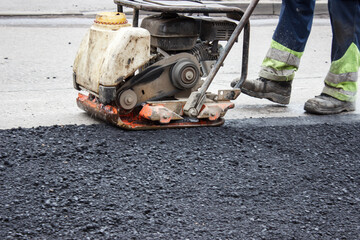 asphalt rammer. laying the road surface