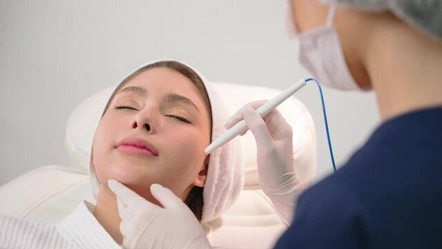 Beauty clinic - Professional cosmetologist performs DermaPen procedure in cosmetology clinic. Beauty concept. Face cosmetic procedure. body business concept.