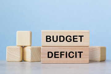 BUDGET DEFICIT . WOODEN BARS with information on the desktop.
