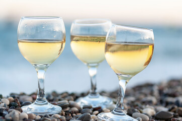 Reflection of two glasses of white wine on tropical beach