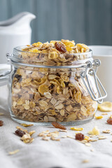 Glass jar with whole grains for breakfast. Muesli with dried fruits and dried fruits. With copy space.