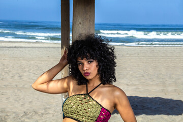 beautiful latin woman with brazilian look with sexy lips posing on the beach in summer