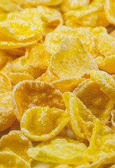 Yellow Cornflakes close up photo, Food texture background, top view. Macro shot. Perfect breakfast.