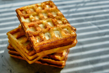 Waffles on kitchen marble countertop, morning breakfast, sunlight through blind.