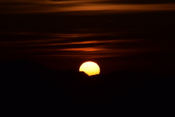 Beautiful picture of orange big sun at the time of sunrise. dark orange sky in background. Selective focus, Selective Focus On Subject, Background Blur