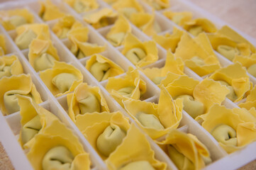 pansoti al prebuggiun is the name of this typical Ligurian stuffed pasta similar to a large tortellino with wild herbs inside called prebuggiun
