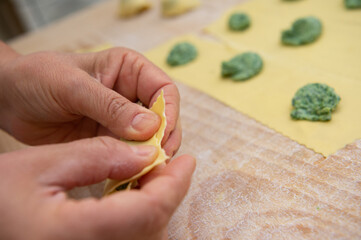 pansoti al prebuggiun is the name of this typical Ligurian stuffed pasta similar to a large tortellino with wild herbs inside called prebuggiun