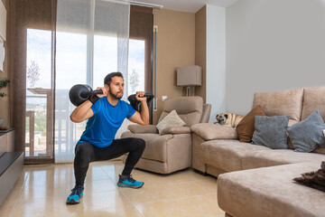 Fototapeta na wymiar Latin man performing a cross fit workout at home