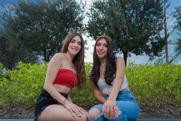 two girls smiling in a garden of a corporate plaza