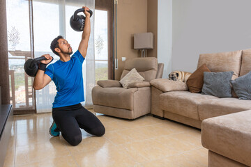 Fototapeta na wymiar Latin man performing a cross fit workout at home
